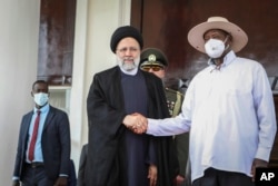 ایران کے صدرابراہیم رئیسی یوگنڈا کے دورے کے دوران صدر یوویری موسیوینی سے اسٹیٹ ہاؤس میں ہاتھ ملا رہے ہیں،فوٹو اے پی ،12 جولائی 2023