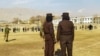 طالبان سیکیورٹی اہل کار صوبہ پروان کے شہر چاکریکار کے فٹ بال اسٹیڈیم کی نگرانی کر رہے ہیں جہاں دو خواتین کو سرعام کوڑے مارے گئے۔ حالیہ دنوں میں طالبان کھلے عام 27 افراد کو کوڑے مارنے کی سزائیں دے چکے ہیں۔