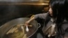 Châu Đặng Haller, chủ nhà hàng Việt Brodard Chateau, thử nước dùng phở trong bếp của nhà hàng tại Garden Grove, California.