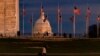 WASHINGTON, DC - DECEMBER 26: The US Capitol Building is seen past the Washington Monument as the sun sets on December 26, 2020 in Washington, DC. Lawmakers in Congress are continuing to work on the coronavirus relief package following President…